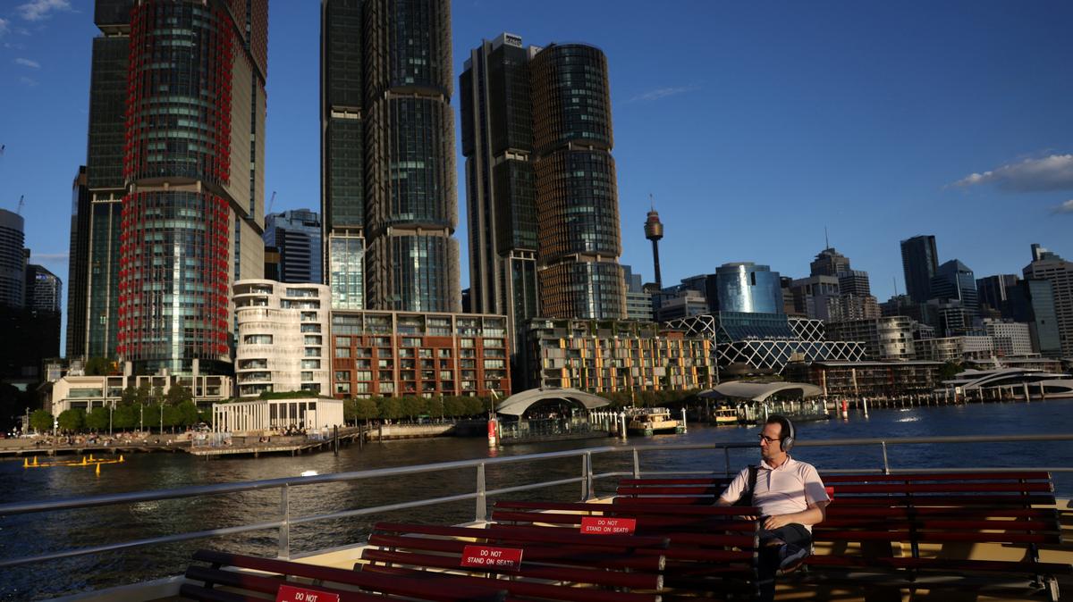 A commuter rides the ferry past the Barangaroo skyline in Sydney, Australia, March 25, 2026. REUTERS/Hollie Adams