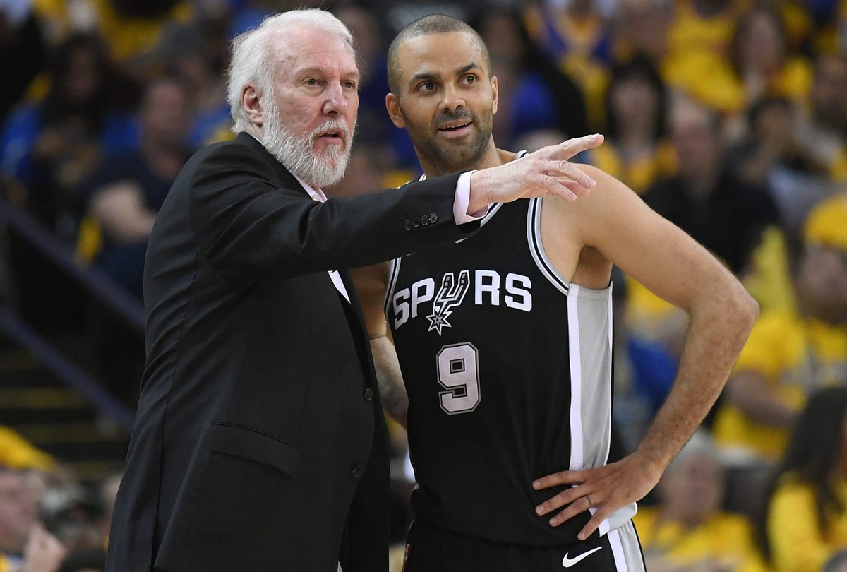  OAKLAND, CA - APRIL 14: Head coach Gregg Popovich of the San Antonio Spurs talks with his player Tony Parker #9 against the Golden State Warriors in the second quarter during Game One of the first round of the 2018 NBA Playoff at ORACLE Arena on April 14, 2018 in Oakland, California. (Photo by Thearon W. Henderson/Getty Images) 