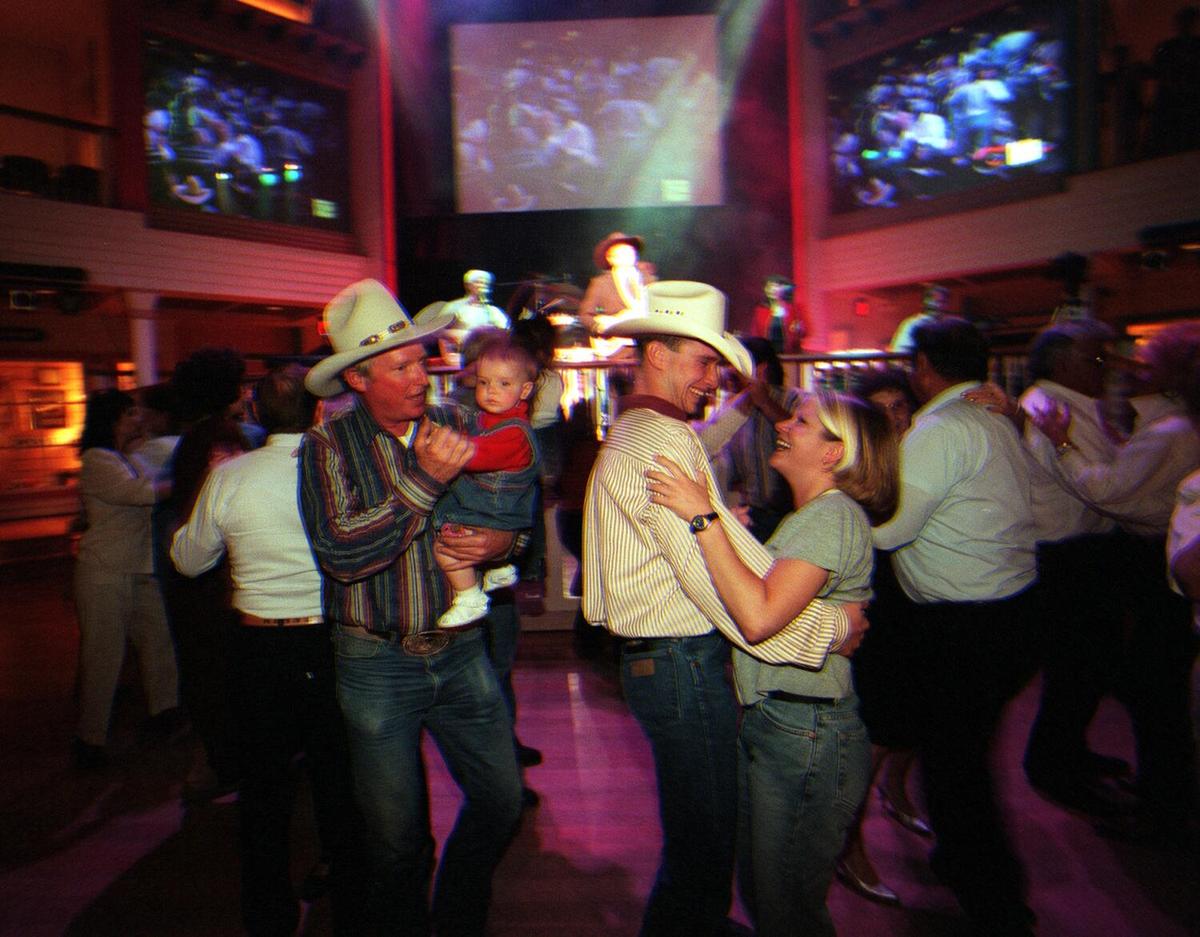 People enjoy the dancing and music of Buck Owens at the Buck Owens Crystal Palace in Bakersfield on May 15, 1998.