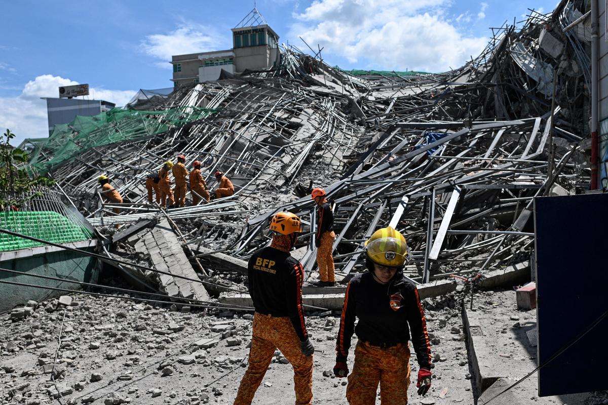 Rescue workers search for survivors among debris as a nine-story building under construction collapsed in Balibago, Angeles City, Pampanga, Philippines, May 24, 2026. REUTERS