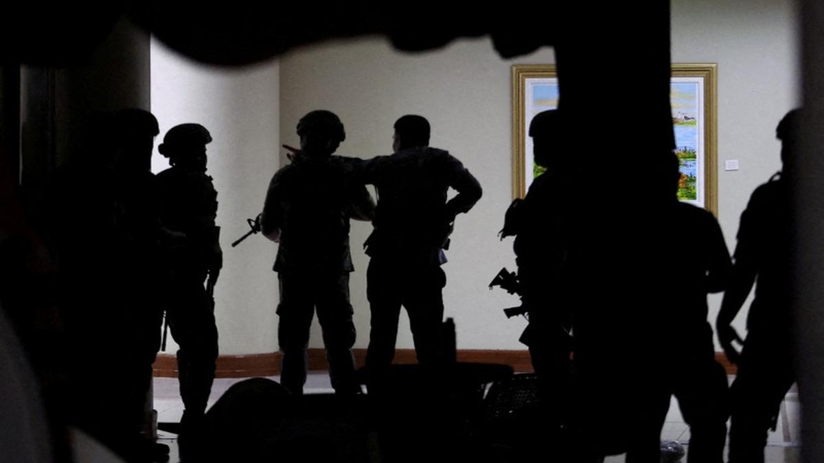 FILE PHOTO: Military personnel in camouflage fatigues enter the Senate building where Philippine Senator Ronald "Bato" dela Rosa, the chief enforcer of former president Rodrigo Duterte's drug war, at the Senate, is under protective custody amid an International Criminal Court warrant, as more than a dozen gunshots were heard at the Philippine Senate on Wednesday, and people were told to run for cover, according to a Reuters witness, in Pasay City, Metro Manila, Philippines, May 13, 2026. REUTERS/Eloisa Lopez       TPX IMAGES OF THE DAY/File Photo