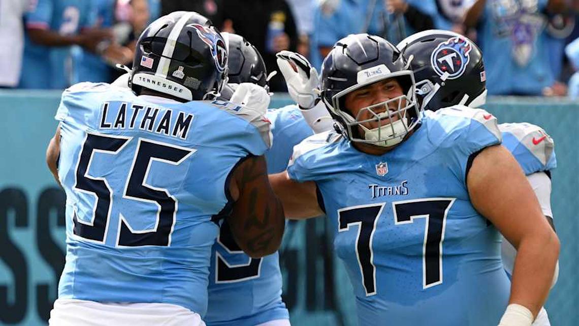 Oct 19, 2025; Nashville, Tennessee, USA; Tennessee Titans offensive tackle Peter Skoronski (77) and teammates celebrates after wide receiver Chimere Dike (17) scored a touchdown against the New England Patriots during the first half at Nissan Stadium. Mandatory Credit: Steve Roberts-Imagn Images | Steve Roberts-Imagn Images 