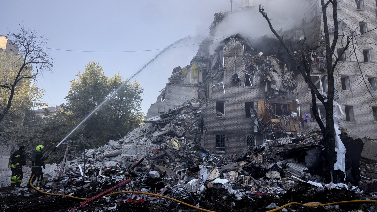 Firefighters work at a building that collapsed as major fires burn at multiple locations after a drone and missile attack by Russian forces on July 2, 2026, in Kyiv, Ukraine. The attack hit multiple buildings in different neighborhoods of the Ukrainian capital, leaving at least 17 dead, according to early statements from Ukrainian authorities. (Paula Bronstein/Getty Images/TNS)