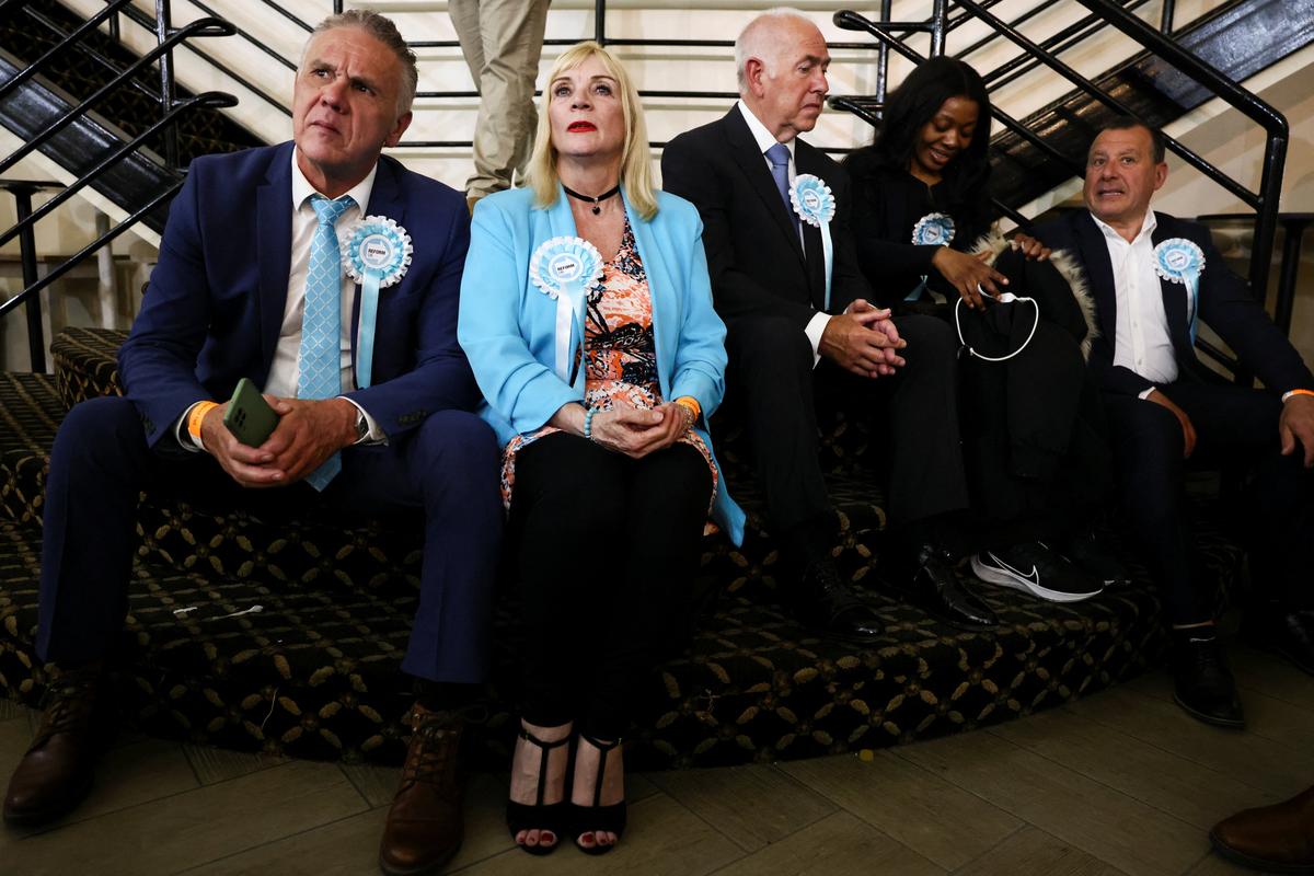 People wear Reform UK party rosettes, following the results of the local elections, in the London Borough of Havering, Britain, May 8, 2026. REUTERS/Jack Taylor