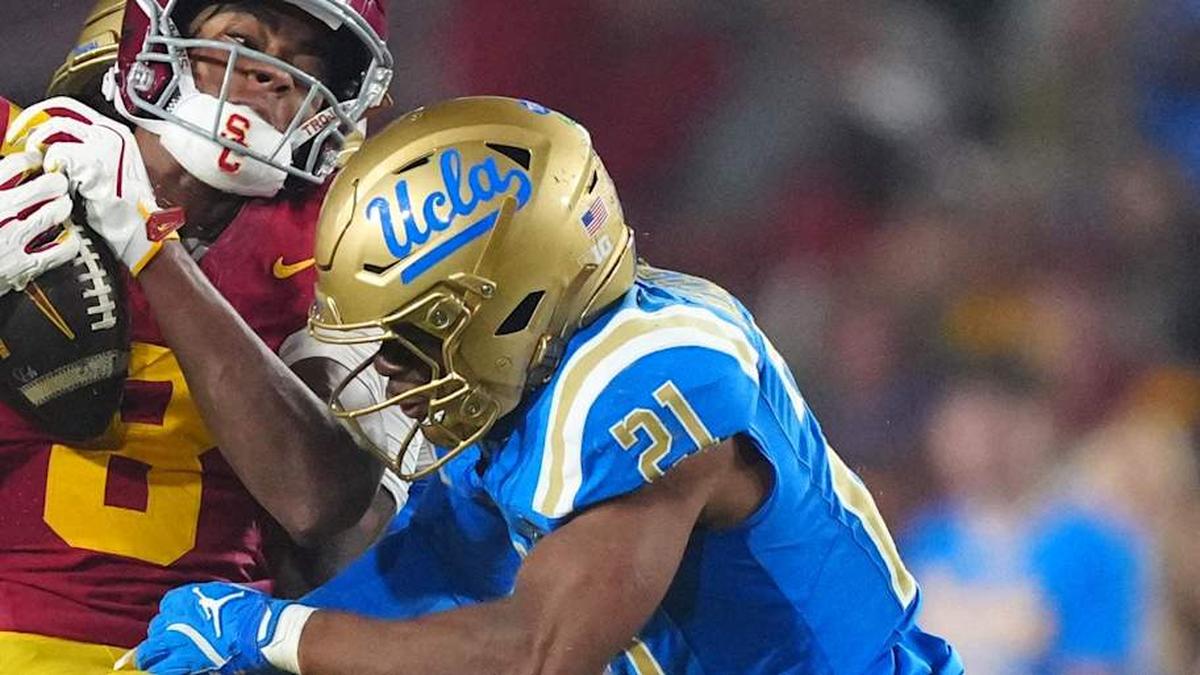  Nov 29, 2025; Los Angeles, California, USA; Southern California Trojans wide receiver Ja'Kobi Lane (8) catches the ball against UCLA Bruins defensive back Cole Martin (21) in the second half at United Airlines Field at Los Angeles Memorial Coliseum. Mandatory Credit: Kirby Lee-Imagn Images | Kirby Lee-Imagn Images 