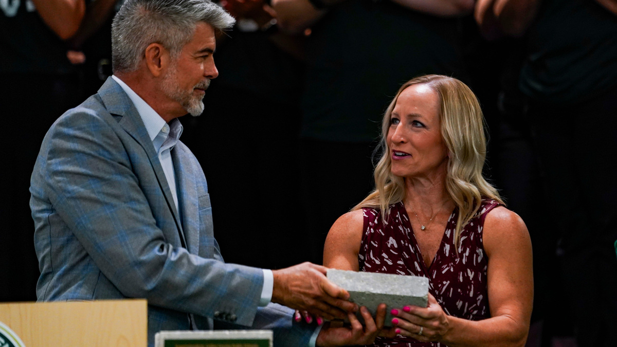 Collier County School Board Chair Kelly Mason is given a commemorative brick during a ribbon cutting ceremony at Bear Creek Elementary School in Naples, Fla., on Friday, Aug. 1, 2025.