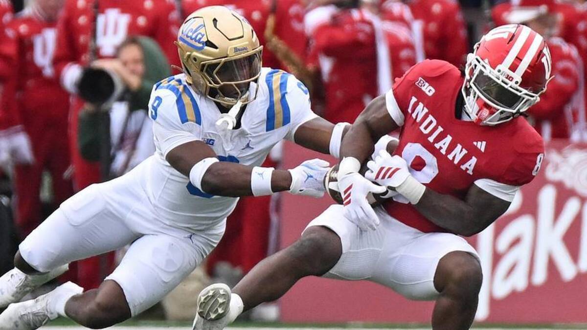  Oct 25, 2025; Bloomington, Indiana, USA; UCLA Bruins linebacker Jalen Woods (9) breaks up a pass intended for Indiana Hoosiers running back Kaelon Black (8) during the first half at Memorial Stadium. Mandatory Credit: Robert Goddin-Imagn Images | Robert Goddin-Imagn Images 