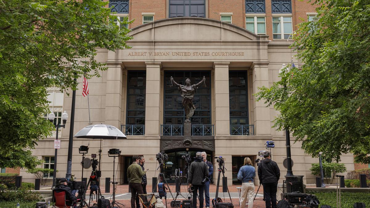 Reporters gather outside of the Albert V. Bryan U.S. Courthouse, where James Comey was to surrender himself, in Alexandria, Va., on Wednesday. Comey, the former FBI director, made his first court appearance on Wednesday after being charged over a photograph of seashells he had posted on social media that the Justice Department branded a serious threat to President Donald Trump.