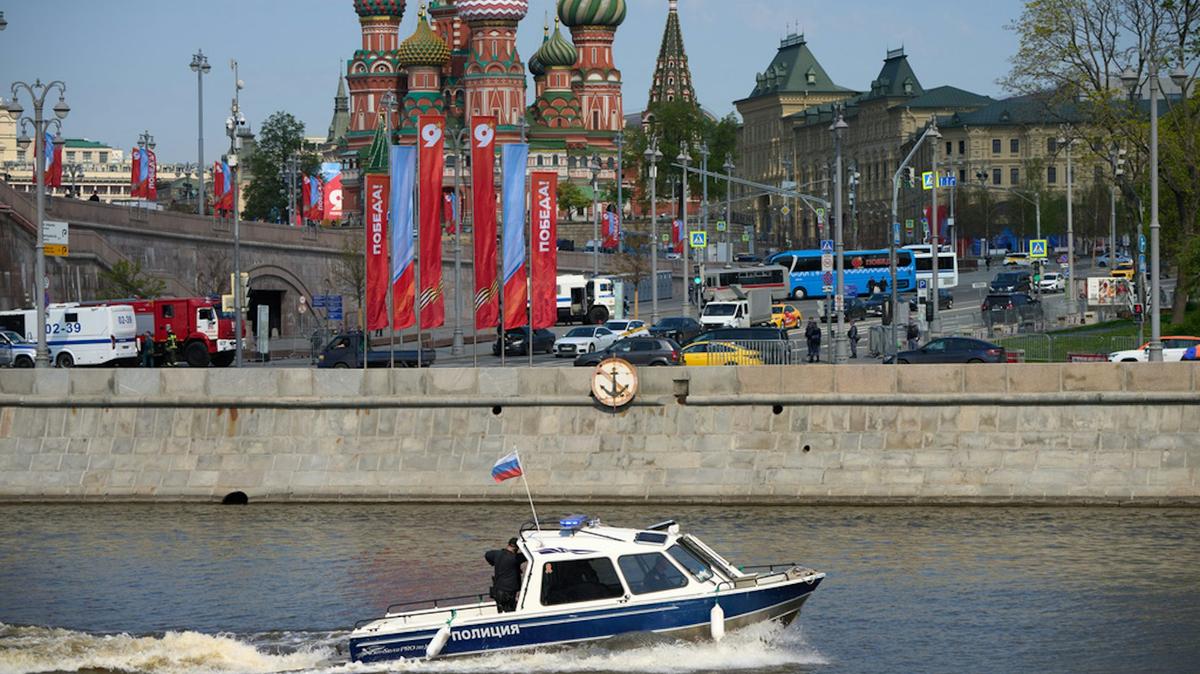 A police boat patrols the waters of the Moskva River near Red Square, which is decorated for the celebration of the 81st anniversary of the Soviet Union's victory over Nazi Germany in World War II. AP Photo/Alexander Zemlianichenko. 