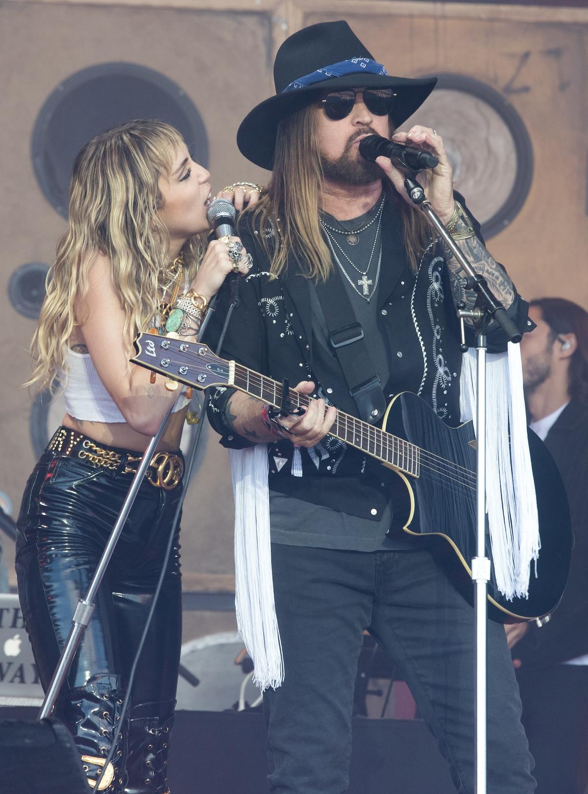 GLASTONBURY, ENGLAND - JUNE 30: Miley Ray Cyrus is joined by her father Billy Ray Cyrus as she performs live on the Pyramid stage during the 2019 Glastonbury Festival at Worthy Farm, Pilton on June 30, 2019 in Glastonbury, England. The festival, founded in 1970, has grown into one of the largest outdoor green field festivals in the world. (Photo by Matt Cardy/Getty Images)