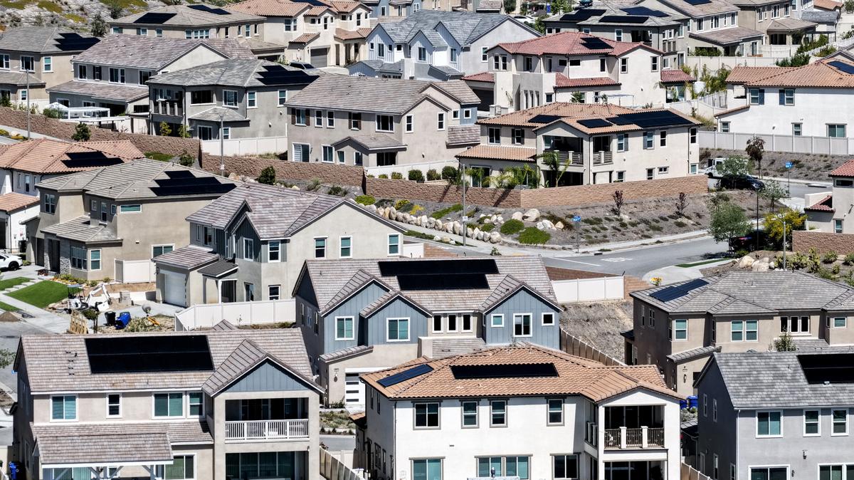 An aerial view shows homes with solar panels in a housing development on April 7, 2026 in Santa Clarita, California. 