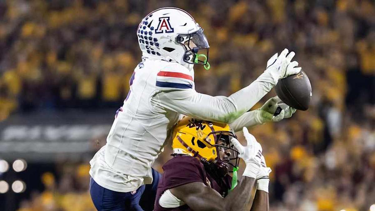  Nov 28, 2025; Tempe, Arizona, USA; Arizona Wildcats defensive back Treydan Stukes (2) intercepts the ball against Arizona State Sun Devils wide receiver Jaren Hamilton (16) in the second half during the 99th Territorial Cup at Mountain America Stadium. Mandatory Credit: Mark J. Rebilas-Imagn Images | Mark J. Rebilas-Imagn Images 