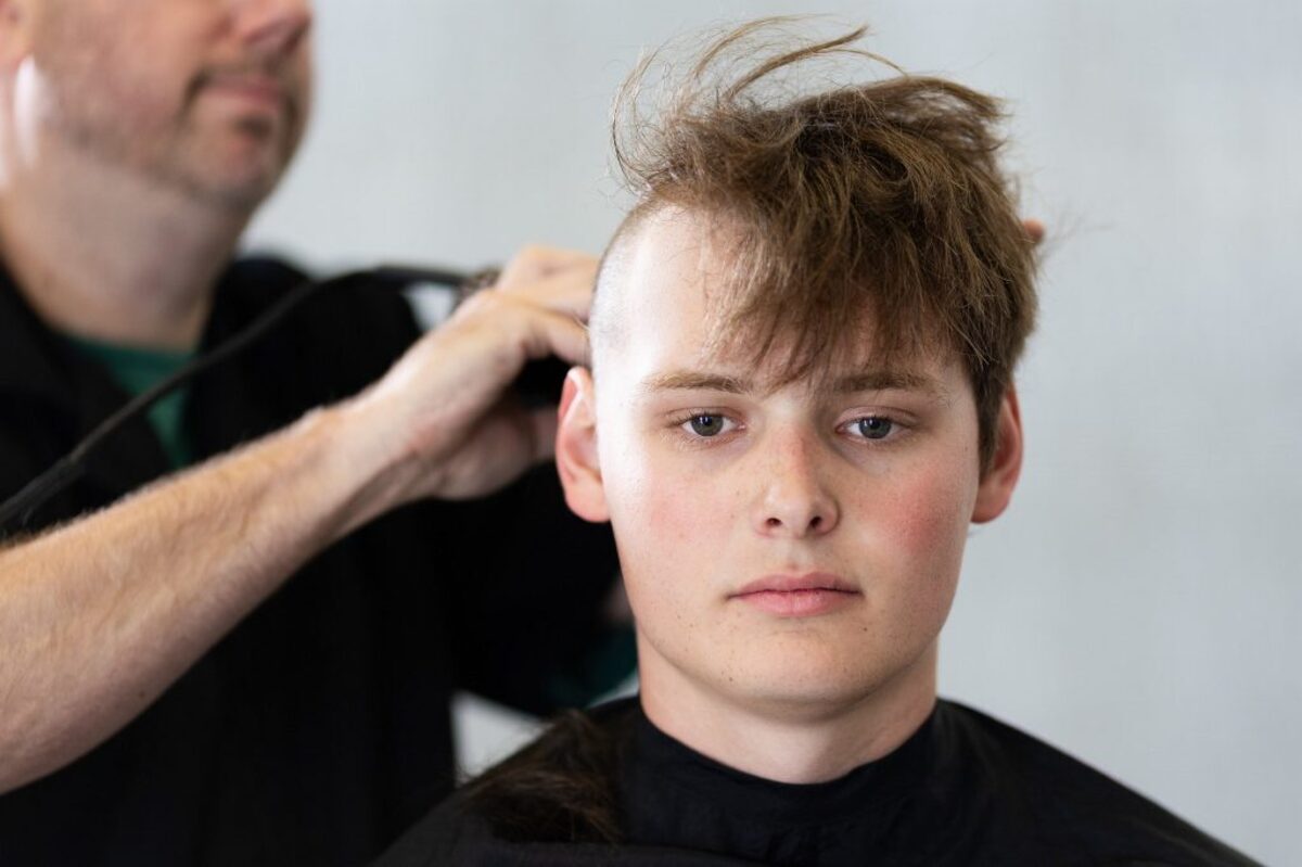  A male basic cadet from the Class of 2030 receives a regulation haircut. (US Air Force Academy via SWNS) 