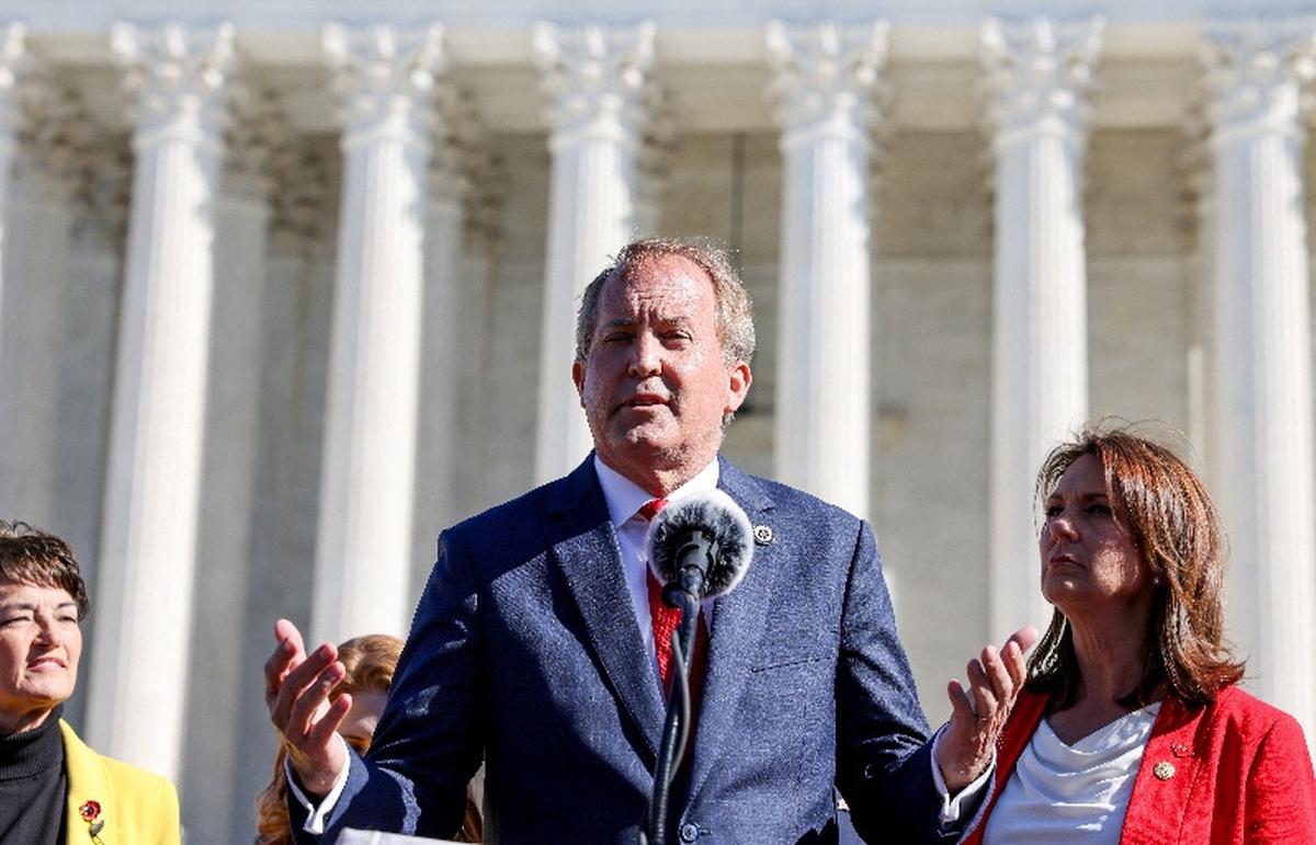 FILE PHOTO: Texas Attorney General Ken Paxton speaks to anti-abortion supporters outside the U.S. Supreme Court following arguments over a challenge to a Texas law that bans abortion after six weeks in Washington, U.S., November 1, 2021. REUTERS/Evelyn Hockstein/File Photo