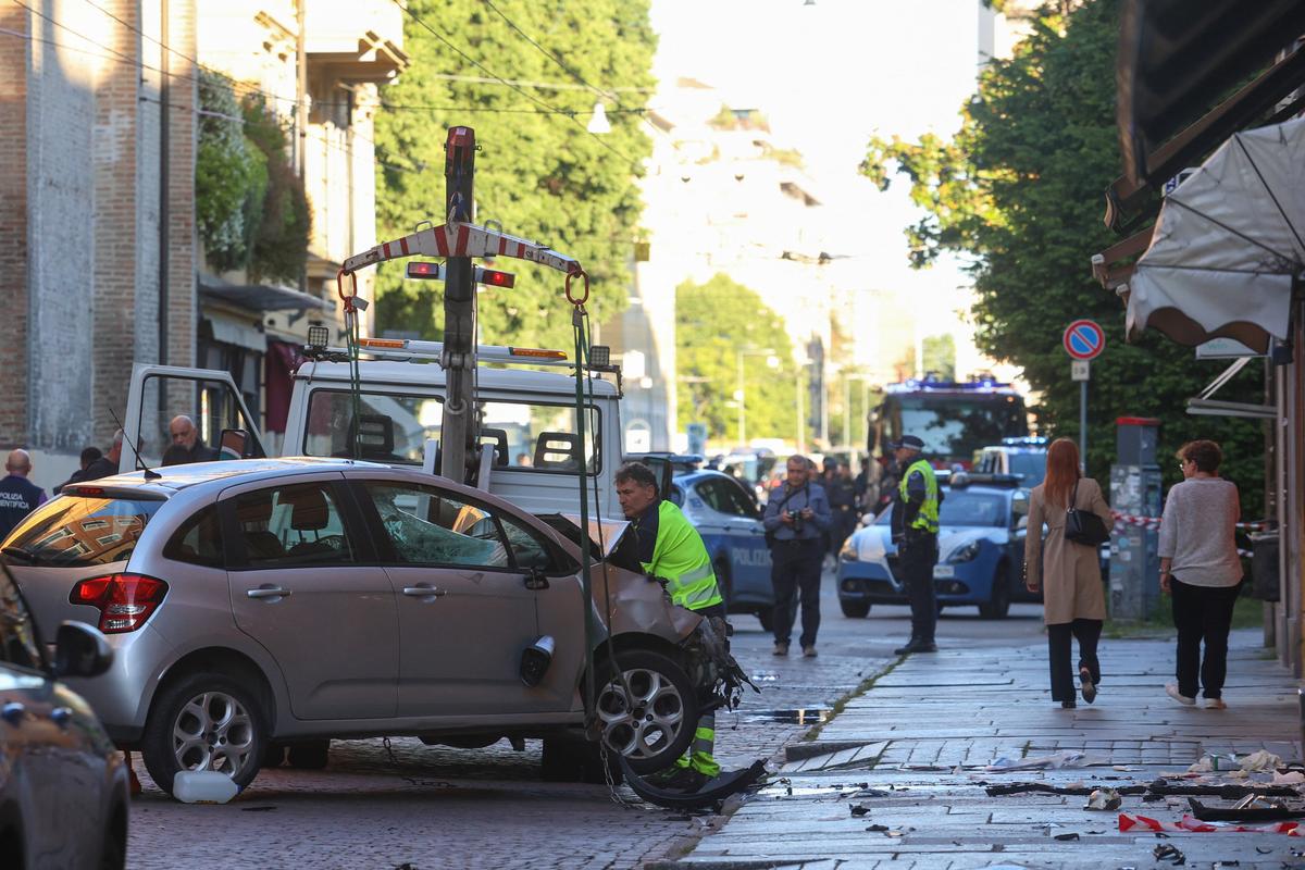 The car that drove into pedestrians is removed from the scene after several people were injured in the center of the northern Italian city of Modena, Italy, May 16, 2026. REUTERS/Stringer
