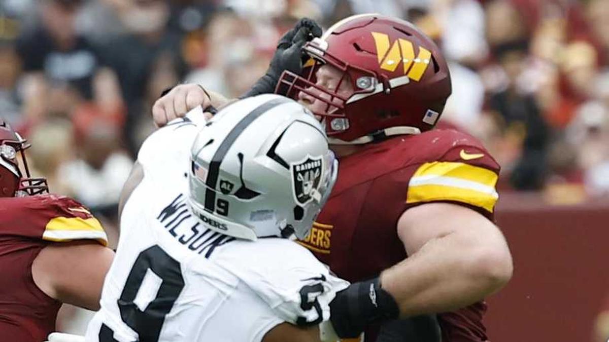  Sep 21, 2025; Landover, Maryland, USA; Washington Commanders quarterback Marcus Mariota (8) passes the ball under pressure from Las Vegas Raiders defensive end Tyree Wilson (9) during the fourth quarter at Northwest Stadium. Mandatory Credit: Geoff Burke-Imagn Images | Geoff Burke-Imagn Images 