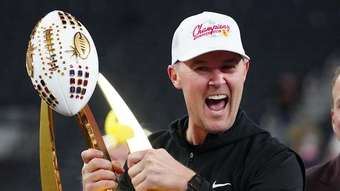  Dec 27, 2024; Las Vegas, NV, USA; Southern California Trojans head coach Lincoln Riley holds the championship trophy after the game against the Texas A&M Aggies at Allegiant Stadium. Mandatory Credit: Kirby Lee-Imagn Images | Kirby Lee-Imagn Images 