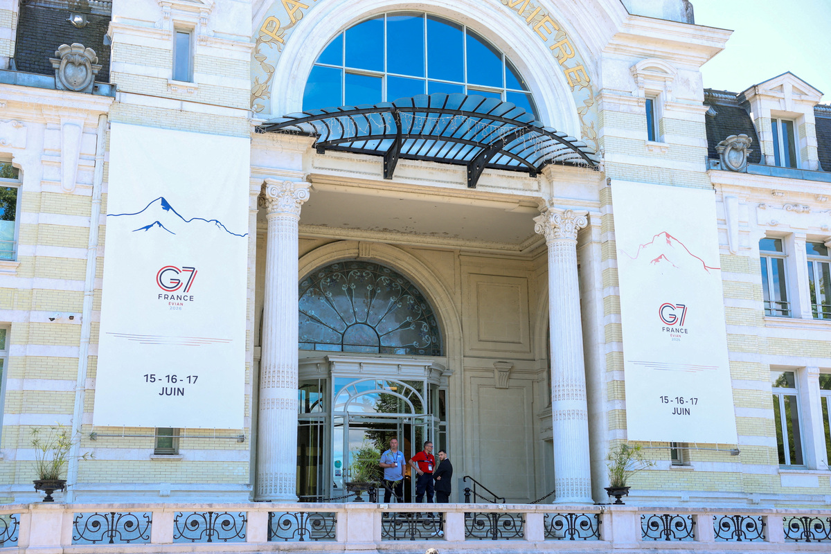 FILE PHOTO: People stand outside the Palais Lumiere ahead of the G7 summit in Evian-les-Bains, France, June 12, 2026. REUTERS/Denis Baliboouse/File Photo