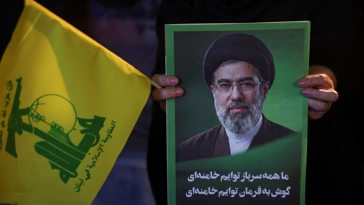 A woman holds an image of Iran's Supreme Leader, Mojtaba Khamenei, and a Hezbollah flag during a rally in Tehran, Iran, June 1, 2026. Majid Asgaripour/WANA (West Asia News Agency) via REUTERS