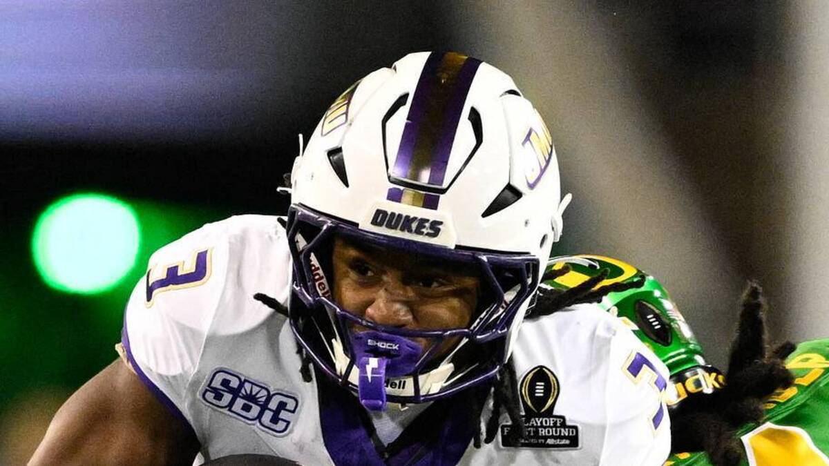  Dec 20, 2025; Eugene, OR, USA; James Madison Dukes running back Wayne Knight (3) rushes as Oregon Ducks defensive back Aaron Flowers (21) defends during the second quarter at Autzen Stadium. Mandatory Credit: Troy Wayrynen-Imagn Images | IMAGN IMAGES via Reuters Connect 