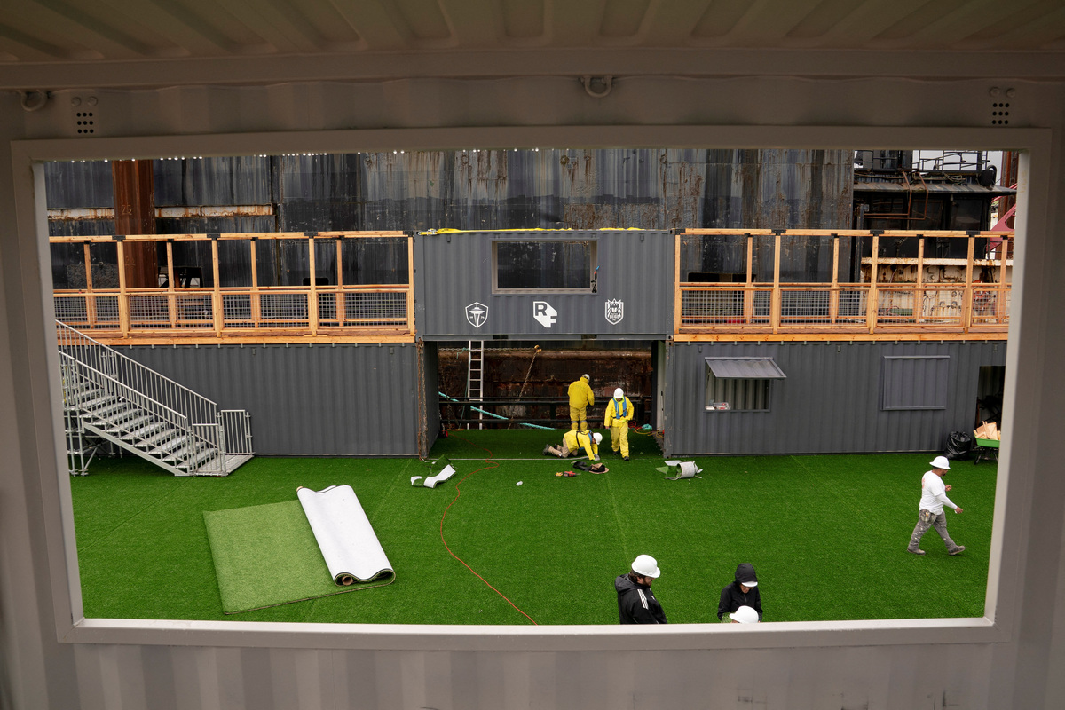 Workers construct a floating pitch and event space on a barge, dubbed the Seattle Soccer Celebration, which will be home to watch parties and events organized and hosted by Seattle Sounders FC, Seattle Reign FC, and RAVE Foundation while located on the Seattle waterfront during the FIFA World Cup 2026, in Everett, Washington, U.S., June 4, 2026. REUTERS/David Ryder