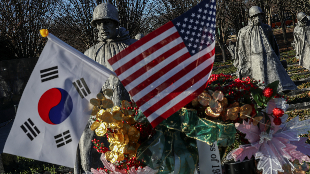 South Korea and U.S. flags are seen at the Korean War Veterans Memorial in Washington, D.C., U.S. December 24, 2025. REUTERS/Tyrone Siu