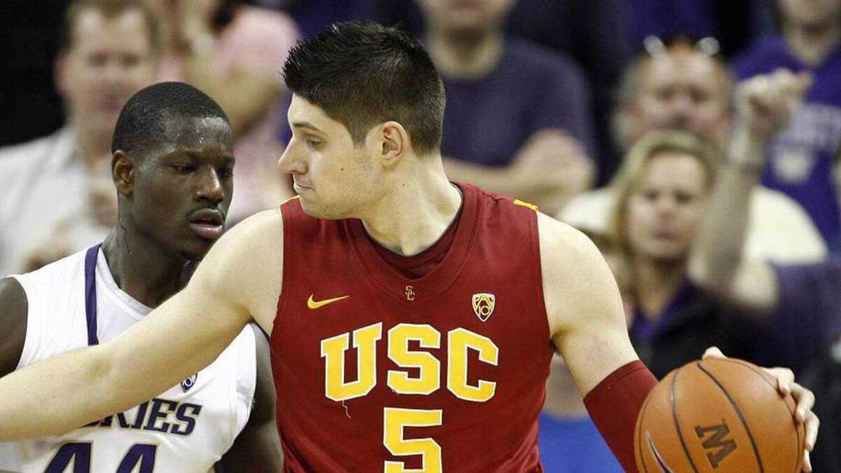  Mar 5, 2011; Seattle, WA, USA; USC Trojans forward Nikola Vucevic (5) dribbles against Washington Huskies forward Darnell Gant (44) during the second half at Alaska Airlines Arena. USC defeated Washington 62-60. Mandatory Credit: Joe Nicholson-Imagn Images | Joe Nicholson-Imagn Images 