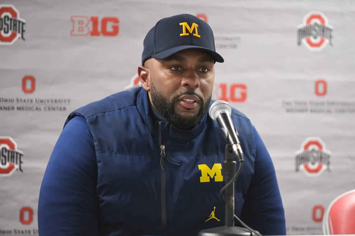  COLUMBUS, OHIO - NOVEMBER 30: Head Coach Sherrone Moore of the Michigan Wolverines speaks to media during the post game press conference after a college football game against the Ohio State Buckeyes at Ohio Stadium on November 30, 2024 in Columbus, OH. The Michigan Wolverines won the game 13-10. (Photo by Aaron J. Thornton/Getty Images) 