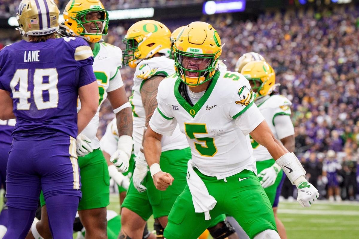 Oregon quarterback Dante Moore celebrates a touchdown as the Oregon Ducks take on the Washington Huskies on Nov. 29, 2025, at Husky Stadium in Seattle, Washington.                	