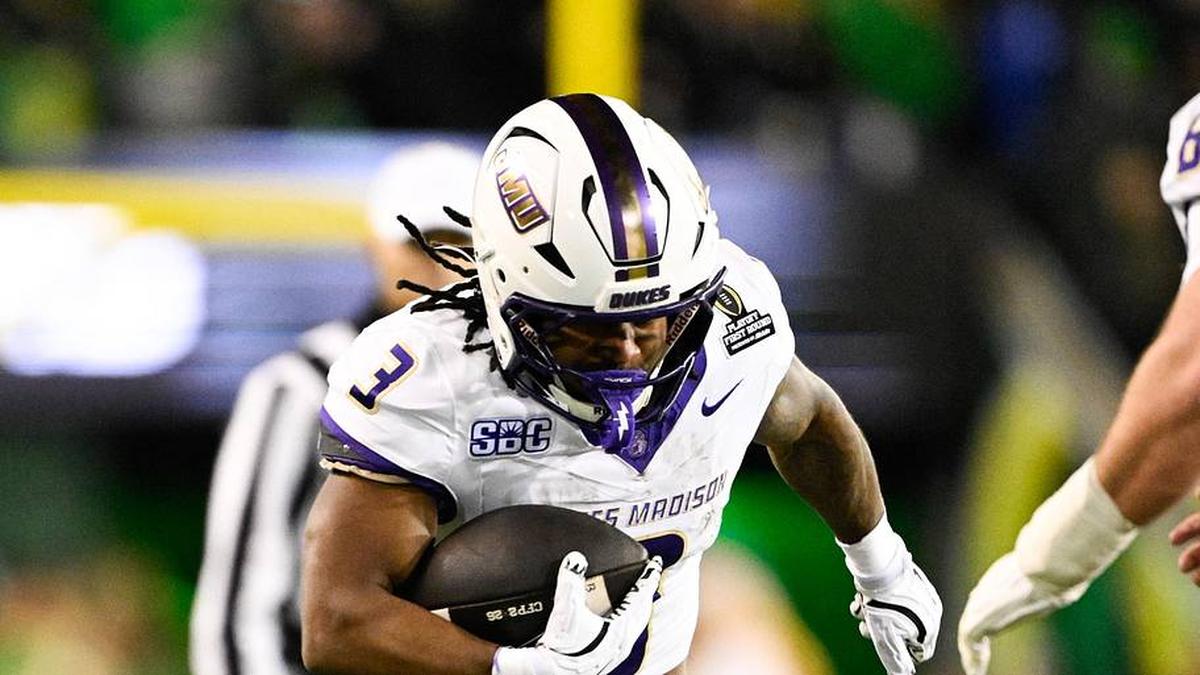  Dec 20, 2025; Eugene, OR, USA; James Madison Dukes running back Wayne Knight (3) rushes as Oregon Ducks defensive back Aaron Flowers (21) defends during the second quarter at Autzen Stadium. Mandatory Credit: Troy Wayrynen-Imagn Images | Troy Wayrynen-Imagn Images 