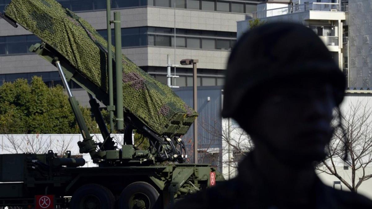A soldier is silhouetted as he stands at guard before Patriot Advanced Capability (PAC-3) surface-to-air missile units at the Defense Ministry in Tokyo, Japan. Photo by FRANCK ROBICHON / EPA