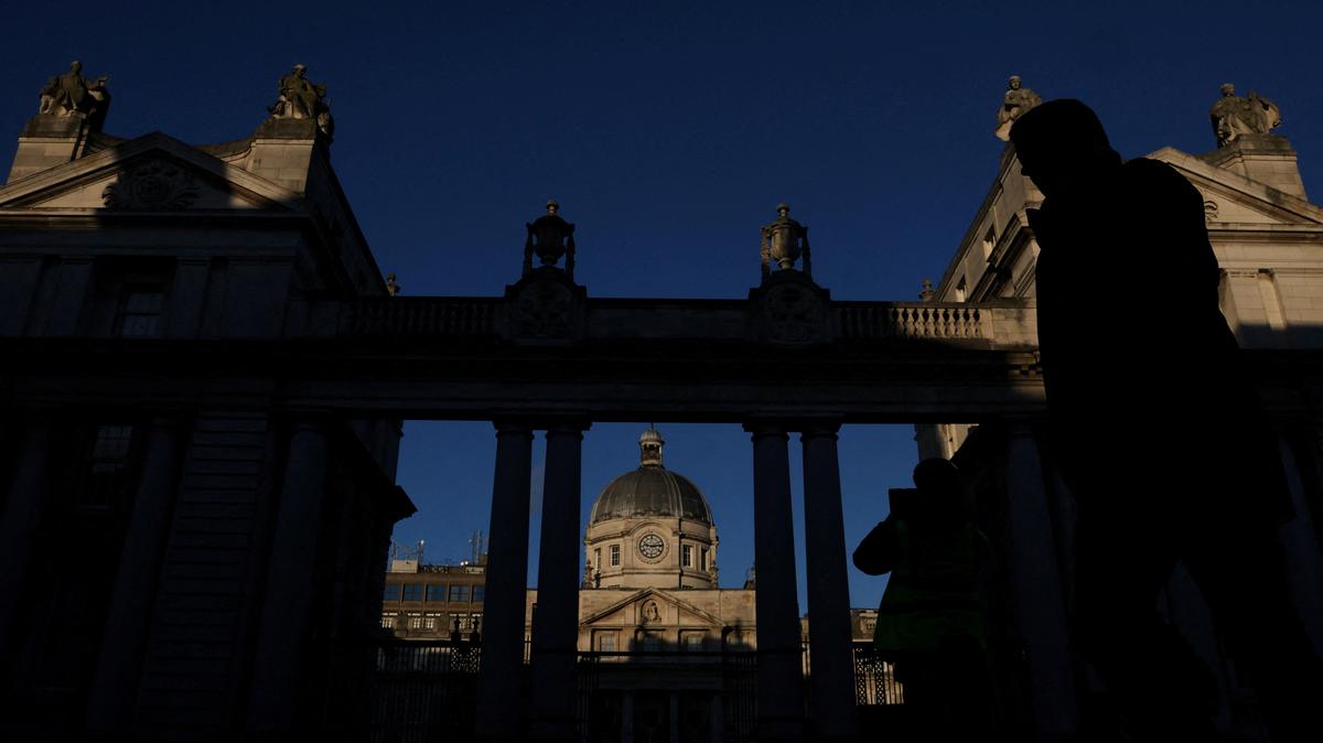FILE PHOTO: A person walks past Government Buildings, the Department of the Taoiseach (Prime Minister) ahead of Ireland's general election, in Dublin, Ireland November 27, 2024. REUTERS/Toby Melville/File Photo