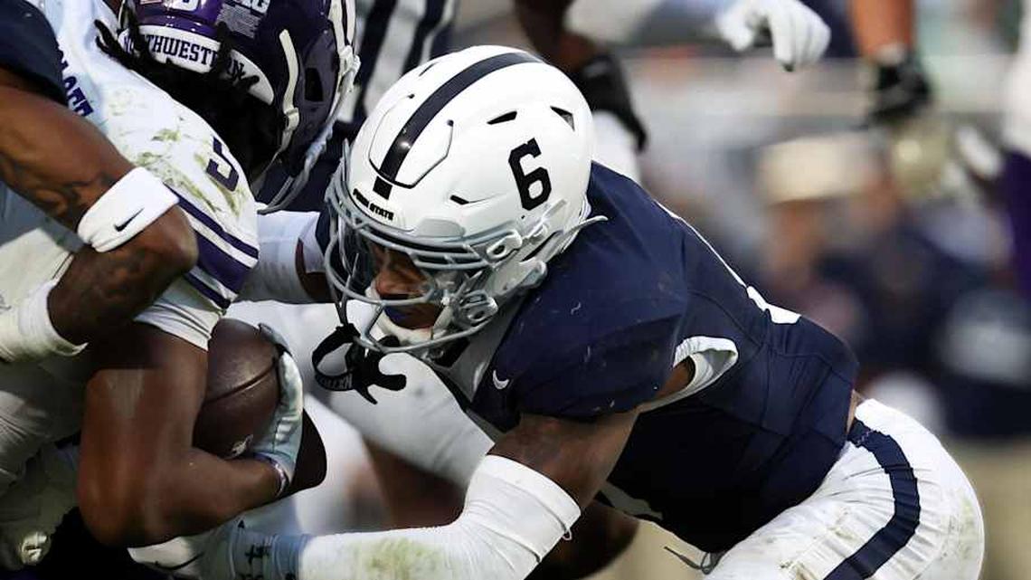  Oct 11, 2025; University Park, Pennsylvania, USA; Penn State Nittany Lions cornerback Audavion Collins (2) and safety Zakee Wheatley (6) tackle Northwestern Wildcats running back Caleb Komolafe (5) during the fourth quarter at Beaver Stadium. Mandatory Credit: Matthew O'Haren-Imagn Images | Matthew O'Haren-Imagn Images 