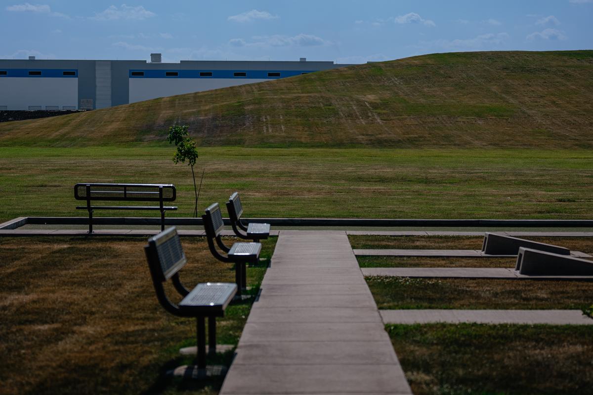 Large warehouses loom in the distance at a community park in Elwood, Ill. on July 1, 2025. This year, a 1.1 million-square-foot logistics facility is expected to open beside the only school in Elwood. (Jamie Kelter Davis/The New York Times)....