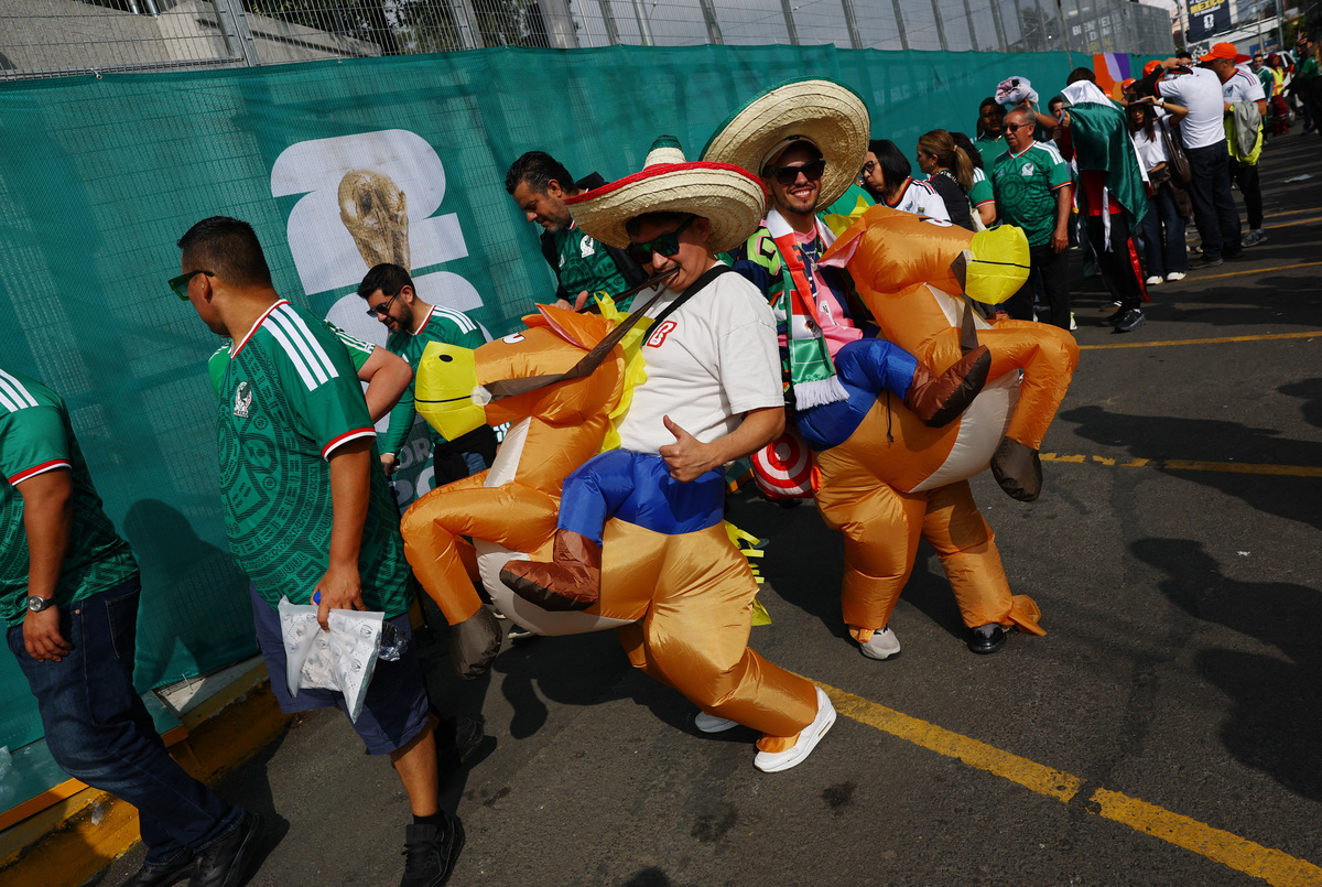 Soccer Football - FIFA World Cup 2026 - Group A - Mexico v South Africa - Estadio Azteca, Mexico City, Mexico - June 11, 2026 Mexico fans wear costumes as they enter the stadium before the match REUTERS/Kai Pfaffenbach