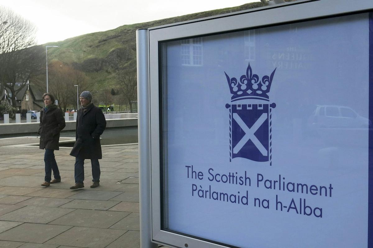  People walk past the Scottish Parliament in Edinburgh. AP Photo / Jill Lawless 