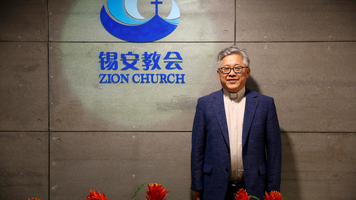 FILE PHOTO: The head pastor of the Zion church in Beijing Jin Mingri poses for picures in the lobby of the unofficial Protestant "house" church in Beijing, China, August 28, 2018.  Picture taken August 28, 2018.  REUTERS/Thomas Peter/File Photo