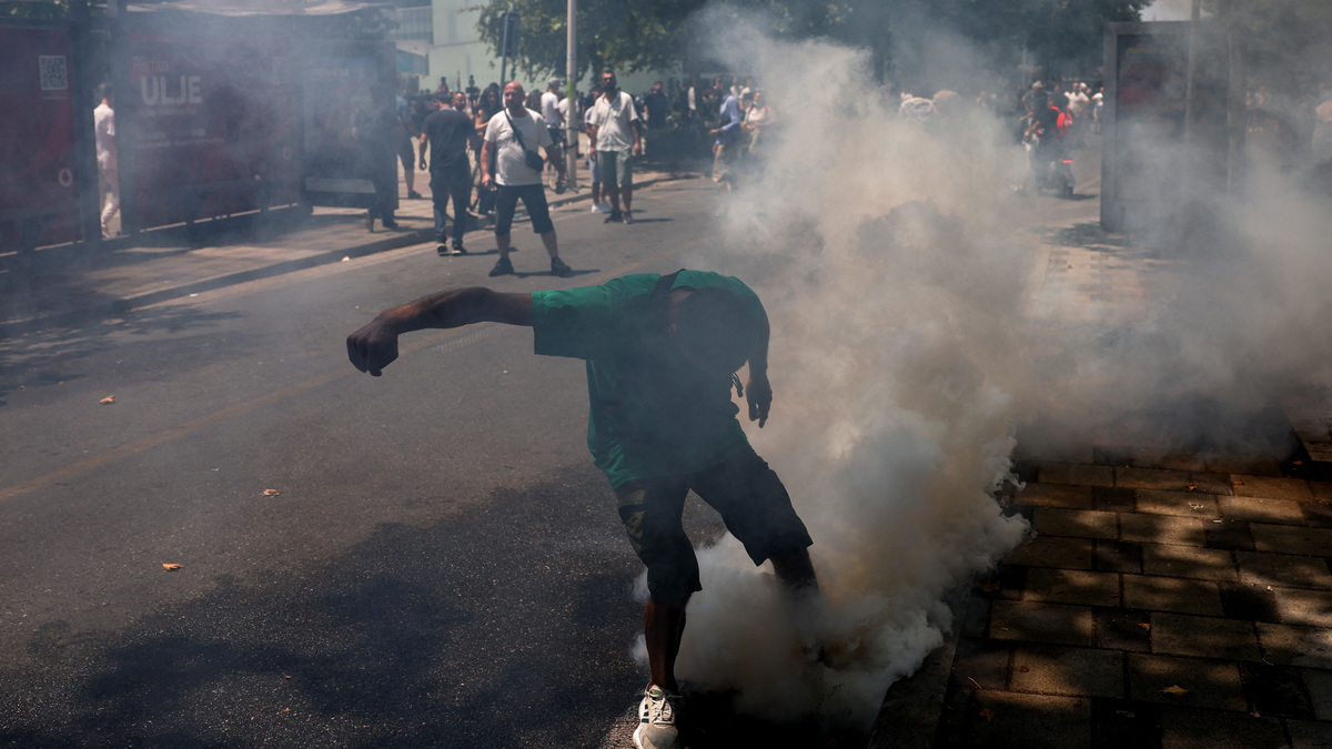 A person attemps to kick a tear gas canister, during a demonstration against the government, following weeks of protests against a planned luxury resort backed by a company linked to Jared Kushner, the son-in-law of U.S. President Donald Trump, on an environmentally sensitive part of the Adriatic coast, in Tirana, Albania, July 2, 2026. REUTERS/Florion Goga