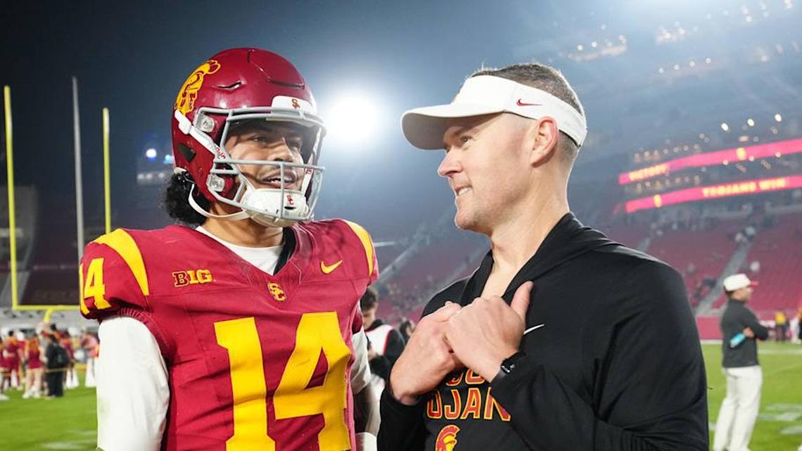  Nov 29, 2025; Los Angeles, California, USA; Southern California Trojans quarterback Jayden Maiava (14) and head coach Lincoln Riley react after the game against the UCLA Bruins at United Airlines Field at Los Angeles Memorial Coliseum. Mandatory Credit: Kirby Lee-Imagn Images | Kirby Lee-Imagn Images 