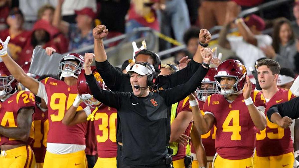  Oct 11, 2025; Los Angeles, California, USA; USC Trojans head coach Lincoln Riley (wearing white visor) celebrates along with defensive end coach Shaun Nua after kicker Ryon Sayeri (48) hit a 54-yard field goal in the second half against the Michigan Wolverines at United Airlines Field at the Los Angeles Memorial Coliseum. Mandatory Credit: Jayne Kamin-Oncea-Imagn Images | Jayne Kamin-Oncea-Imagn Images 