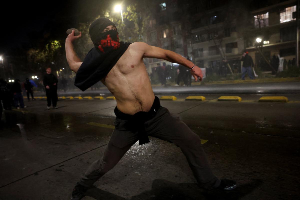 A demonstrator prepares to throw a stone during a protest against the policies of Chile's President Jose Antonio Kast, in Santiago, Chile, June 1, 2026. REUTERS/Pablo Sanhueza