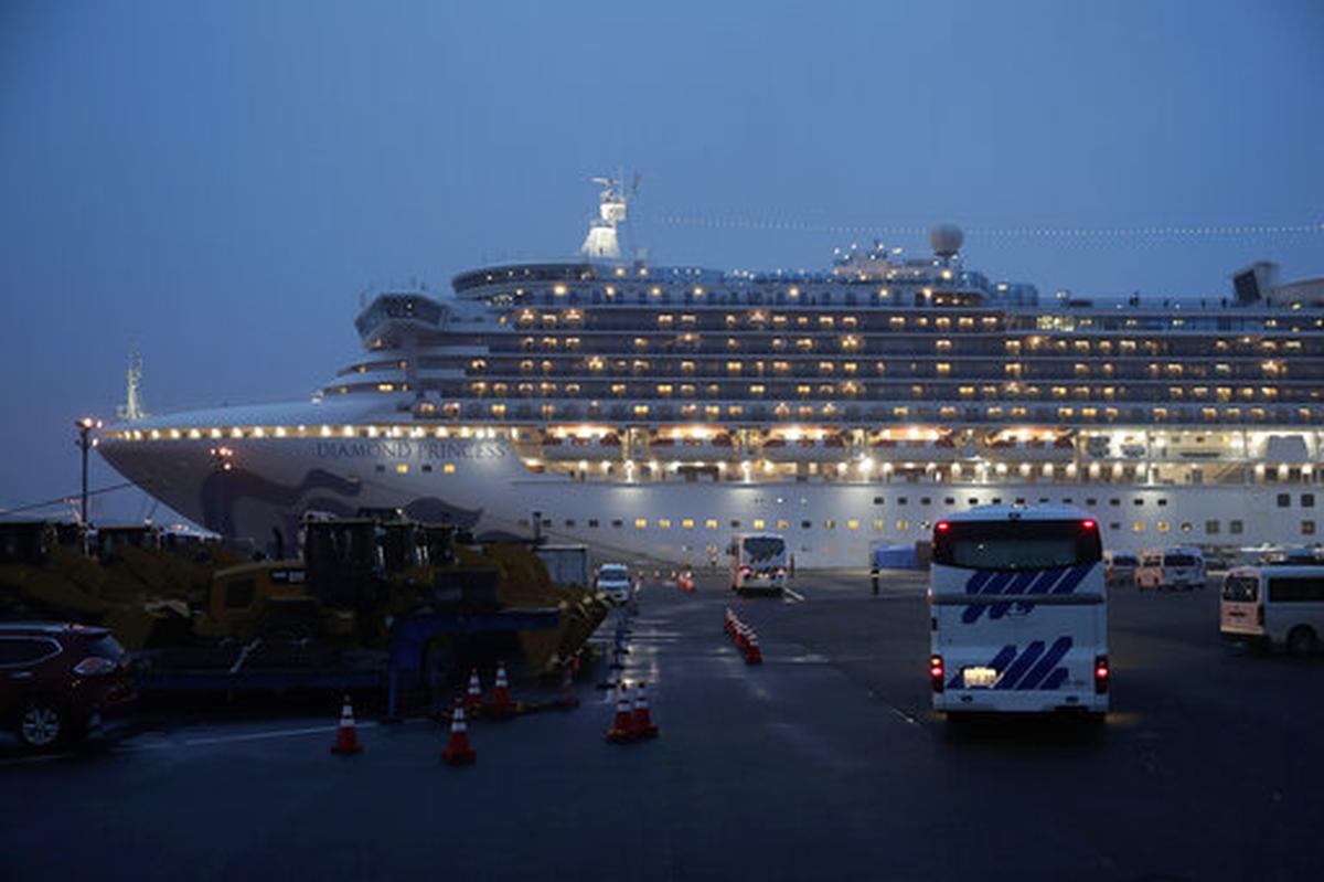 Buses arrive at a port as the Japan Self-Defense Forces prepare to move American passengers from the quarantined Diamond Princess cruise ship Sunday, Feb. 16, 2020, at Yokohama Port, near Tokyo.