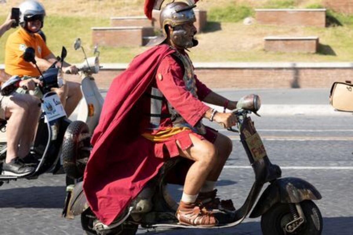 A man wearing a costume drives a Vespa near the Fori Imperiali on the last day of “Vespa Roma 2026 - 80 Years of an Icon”, a four-day global gathering marking the 80th anniversary of the iconic Italian scooter brand, in Rome, Italy, June 27, 2026. REUTERS/Remo Casilli
