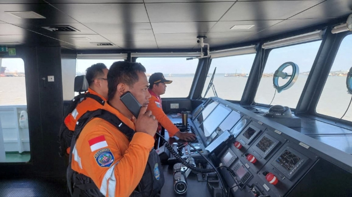 Indonesia rescuers battle turbulent seas in search for 129 people after passenger ship capsizes 