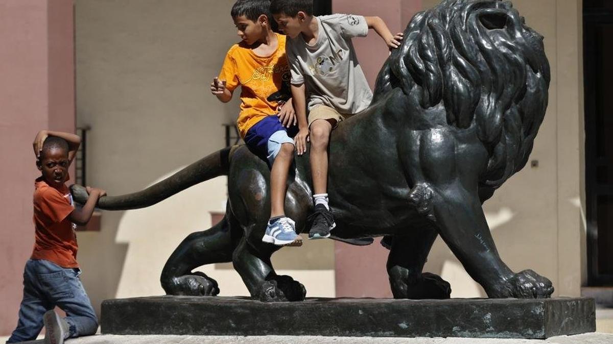 Children play on a sculpture in Havana in April. The Cuban energy crisis and a shortage of teachers and supplies have impacted education at all levels, File Photo by Ernesto Mastrascusa/EPA