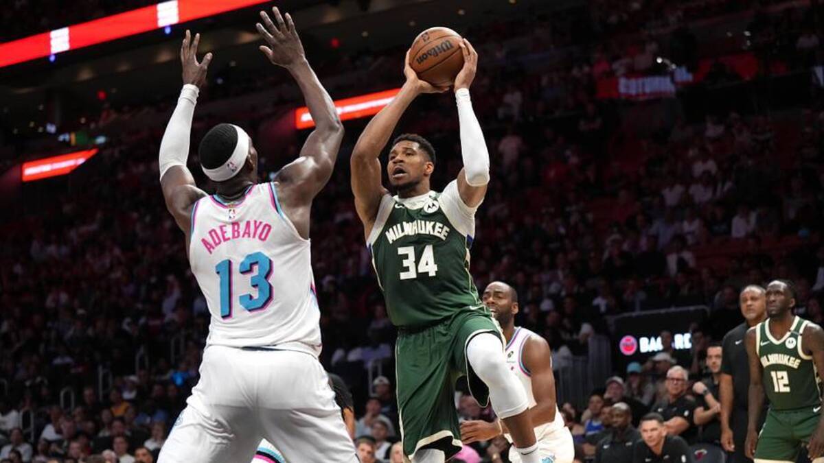  Apr 5, 2025; Miami, Florida, USA; Milwaukee Bucks forward Giannis Antetokounmpo (34) looks to pass the ball as Miami Heat center Bam Adebayo (13) defends during overtime at Kaseya Center. Mandatory Credit: Jim Rassol-Imagn Images | Jim Rassol-Imagn Images 