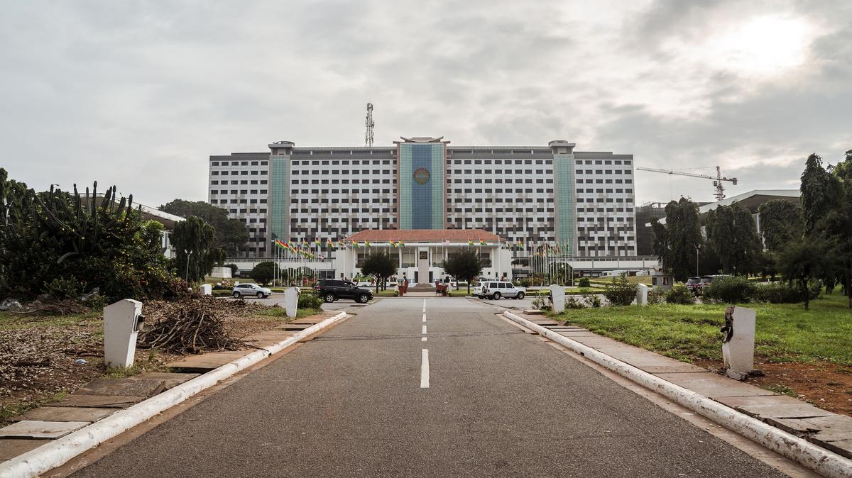 People drive their car past the Ghana's Parliament during a welcome ceremony for a U.S. congressional delegation in Accra, on July 31, 2019, as part of a three-day visit to the country to mark the 400 years anniversary since the first slave shipment left the Ghana's coast for United States. (Natalija Gormalova/AFP/Getty Images/TNS)