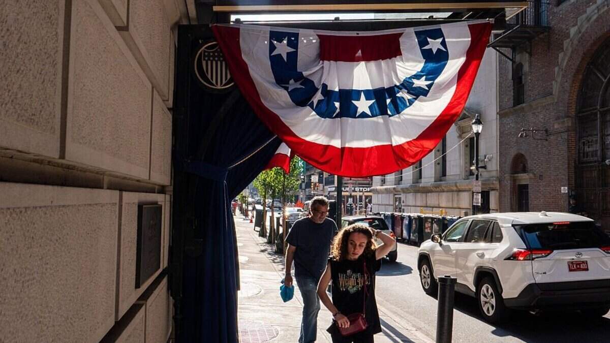 People walk through downtown Philadelphia after news that the Semiquincentennial Independence Day Parade has been canceled due to extreme heat on July 3, 2026 in Philadelphia, Pennsylvania. Philadelphia is celebrating the 250th anniversary of the United States of America.
