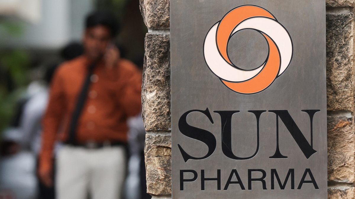 A man speaks on his phone next to the logo of Sun Pharmaceutical Industries Ltd., in Mumbai, India, October 31, 2025. REUTERS/Francis Mascarenhas
