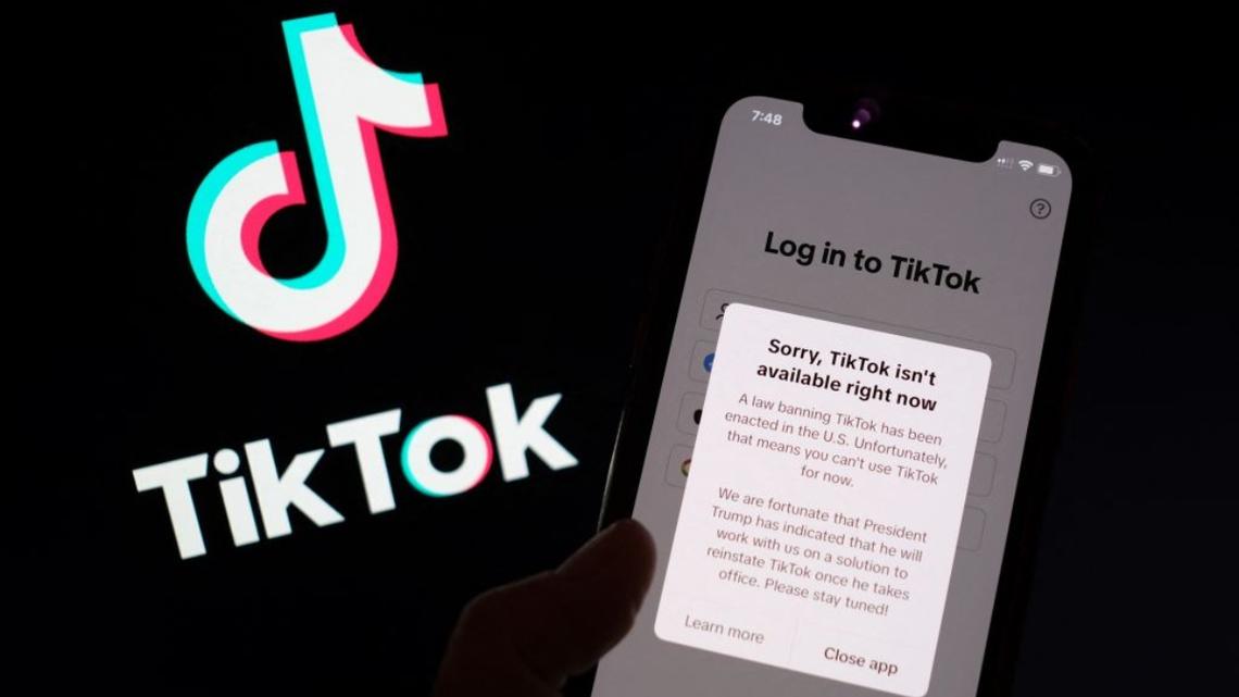 This illustration photo taken in Los Angeles on January 18, 2025, shows the TikTok app on a smartphone screen in front of the TikTok logo. TikTok disconnected access to its users in the United States late January 18 after no action was taken shortly before a national ban was to take effect, in the name of national security, unless its Chinese owners reach a deal to sell it to non-Chinese buyers by January 19, with President-elect Donald Trump unable to intervene until he takes office. “A law banning TikTok has been enacted in the US,” said a message to users attempting to use the app. “Unfortunately, that means you can’t use TikTok for now.” (Photo by Chris DELMAS / AFP)